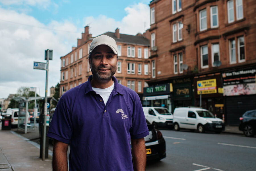 James in his Bethany t-shirt outside the Bethany Shop where he volunteers